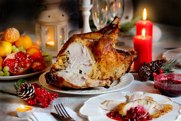 Wall Mural - Christmas turkey with cranberry sauce on the holiday table and candles