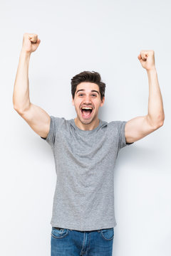portrait of smiling man with the fists up isolated a white background