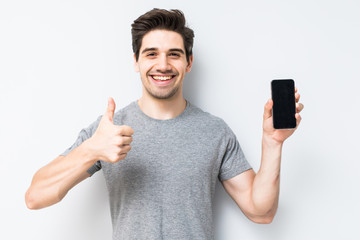 Portrait of a smiling man showing blank smartphone screen isolated on a white background
