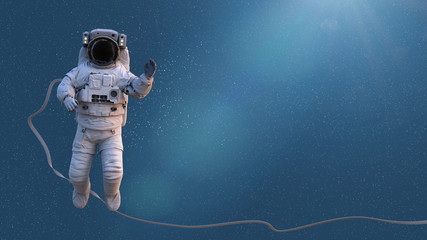Wall Mural - spacewalking astronaut lit by the sun