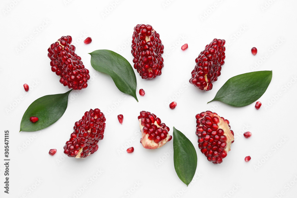 Pieces of ripe tasty pomegranate on white background