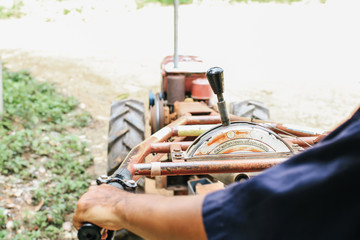 rural scene view from cart of a local tractor and farmer driving down road at Na Ton Chan homestay Sukhothai Province ,Thailand