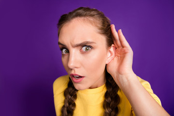 Poster - Closeup photo of funny lady long braids holding arm near ear listening fresh rumours chatterbox person wear casual yellow jumper isolated purple color background