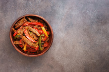 Traditional Mexican Dish Fajitas In A Ceramic Bowl On A Dark Rustic Background. Top View, Flat Lay, Copy Space.