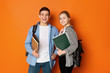 © Prostock-studio - Excited student couple with backpacks and books