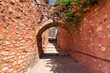 Roussillon narrow street stones steps up alley arch in France Provence