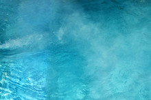 Pure Clear Water In The Thermal Pool. Hot Water Flows And Fog Rises Above The Pool, Steam. Blue Water, Beautiful Background.
