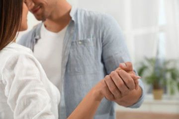 Wall Mural - Happy young couple dancing together at home, closeup