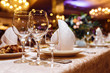 Serving wedding table. Sparkling glassware stands on long table prepared for wedding dinner. Banquet. 