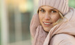 © lashkhidzetim - Portrait of a beautiful young model in pink knitted hat  and mittens. Beautiful natural young smiling blonde woman wearing knitted gloves.