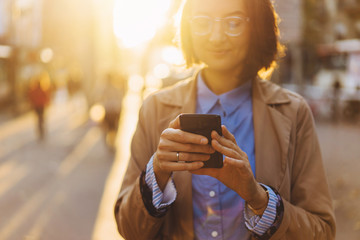 Happy girl cheking message and smiling using 4g wireless for browsing internet and send answer text via cellphone gadget, positive woman with mobile device networking