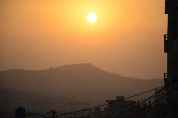 Wall Mural - Dawn over Bethlehem. The city in which Jesus Christ was born. The sun rises over the ancient city with a round disk