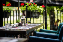 Simple And Elegant Outdoor Restaurant Table Set Up On  Green Background