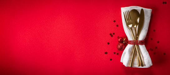 Sticker - Christmas tableware and decorations on red background, top view