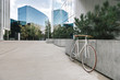 © Hernandez And Sorokina/ADDICTIVE STOCK - Bike parked on sidewalk near wall of contemporary building on sunny day on city street