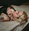 © Natalia Nieves/ADDICTIVE STOCK - Confident pensive freckled woman smoking on bed