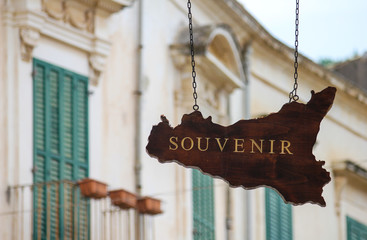 Signboard of a souvenir shop in the shape of Sicily in the town of Scicli in Sicily, Italy