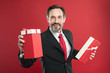 © be free - For you. Happy businessman give presents red background. Mature man smile with presents. Birthday presents. Boxing day. Gift wrapping. Wrap your presents. Welcome to holiday