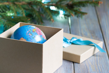 Globe in gift box. Travel gift for Christmas concept 