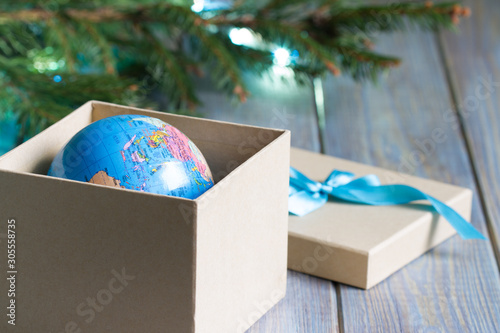 Globe in gift box. Travel gift for Christmas concept