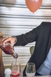 © Sarabua - A man pours champagne in glasses.