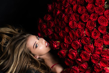 Beautiful Woman With Red Roses. Gift With Love. Beautiful Smiling Girl Holding Large Bouquet Of Red Roses On Black Background. Beautiful Woman With Red Rose Bouquet.