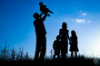 © Kostia - happy family outdoors in the park silhouette