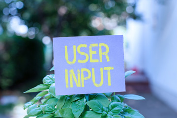 Poster - Handwriting text User Input. Conceptual photo Any information or data that is sent to a computer for processing Plain empty paper attached to a stick and placed in the green leafy plants