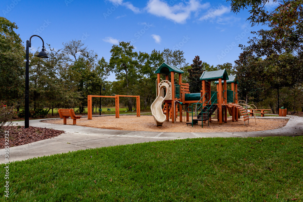 Wooden playground with a slide and swingset - obrazy, fototapety, plakaty 