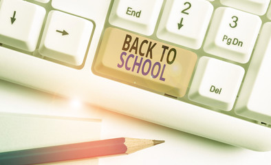 Poster - Word writing text Back To School. Business photo showcasing New Teachers Friends Books Uniforms Promotion Tuition Fee White pc keyboard with empty note paper above white background key copy space