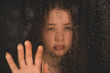 © Beverley - Teenage girl with hand on window in the rain