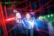© JackF - Girl in colored beams during laser tag game