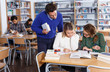 © JackF - Tutor helping girls in library