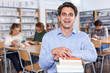 © JackF - Portrait of delighted adult man with books