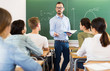 Man teacher giving lecture in classroom