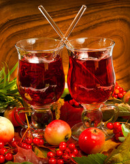 Wall Mural - Mulled wine with fallen autumn leaves, red apples and viburnum berries. Autumn still life.