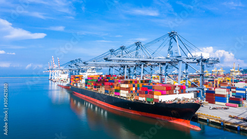 Fotografía Container cargo ship at industrial port in import export business logistic and transportation of international by container cargo ship in the open sea