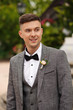 © Wedding photography - Portraip of elegant groom in grey suit at wedding day