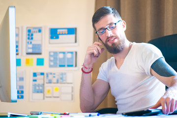 Poster - Man is talking on the phone. Telephone negotiations with business partners. Guy at the desk. Telephone conversations. Man in the office. Man with a cellphone. Conversation with business partners.
