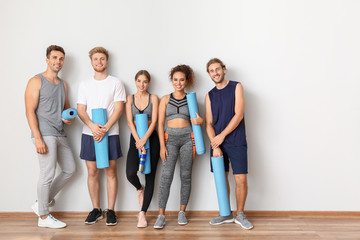 Sticker - Group of people with yoga mats near light wall