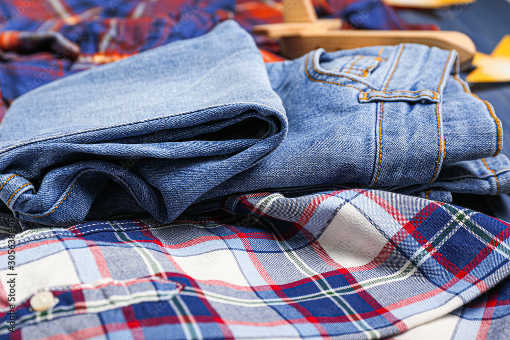 Stylish autumn kid clothes on table, closeup
