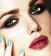 Close-up beauty portrait of beautiful model with bright make-up and manicure. Smoky eyes 