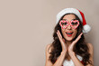 © New Africa - Emotional woman in Christmas costume with party glasses on beige background, space for text
