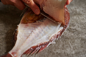 Poster - Filleting red sea bream with knife 