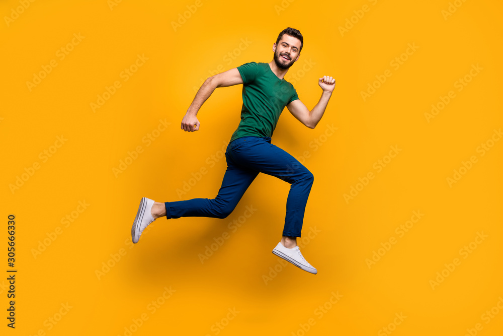 Full size photo of cheerful guy jump run fast for discounts wear modern clothing isolated over yellow color background - obrazy, fototapety, plakaty 