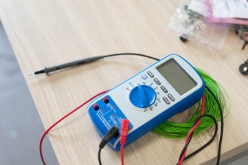 electronic multimeter device isolated on table. true rms multi meter.