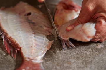 Poster - Filleting red sea bream with knife 