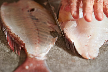 Wall Mural - Filleting red sea bream with knife 