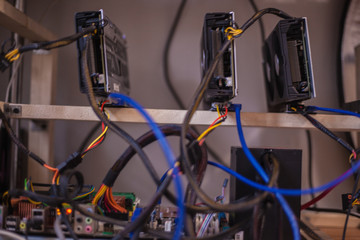 Video cards with on shelves connected to a farm for obtaining electronic money. Close-up. Out of focus. Blur