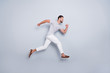 © deagreez - Full length body size view of his he nice attractive muscular sportive cheerful strong bearded guy running fast hurry-up isolated over light grey pastel color background